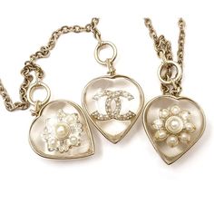 This is part of Chairish’s Costume Jewelry assortment.  Chanel Gold CC Flower Heart Charm Necklace  *Marked 16 *Made in France *Comes with the original box and dustbag  -It is approximately 34" long. -The heart pendants are approximately 2" x 1". -In an excellent condition Luxury Heart-shaped Jewelry With Detachable Pendant, Luxury Heart-shaped Charms Necklace, Luxury Silver Necklace With Flower Charm, Luxury Sterling Silver Heart Necklace, Luxury Heart Pendant Necklace, Luxury Heart Necklace With 17 Jewels, Luxury Double Heart Necklace, Luxury Heart Necklace For Wedding, Luxury Heart Necklace With 17 Jewels As Gift