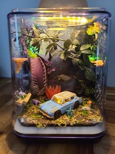 an aquarium with plants and cars inside it