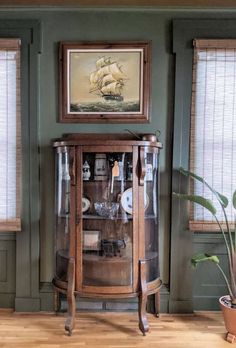 antique curio cabinet and antique oil painting Curio Cabinet Living Room, Curio Cabinet Styling, Curio Cabinet Decor, Living Room Hutch, Antique Display Cabinet, Antique Curio Cabinet, Walnut Interior, Curio Cabinet Displays, Antique Bookshelf