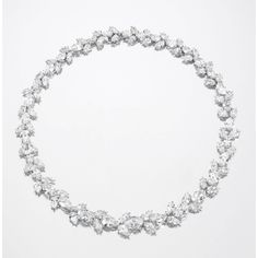 Diamond necklace, 1960s Designed as a graduated series of oval and pear-shaped diamonds interspersed with stylised foliate elements set with pear- and marquise-shaped stones, the three principal oval diamondsweighing 3.00, 3.31 and 3.28 carats respectively, mounted in platinum. JEWELS FROM THE COLLECTION OF LILY MARINHO DIAMOND NECKLACE, 1960S Estimate    190,544 - 381,088USD  LOT SOLD. 503,989 USD White Diamond Jewelry, International Jewelry, Diamond Necklaces, Modern Necklaces, Oval Diamond, White Diamond, Pear Shaped, Diamond White