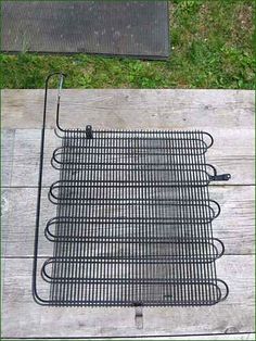 a person standing next to a grill on top of a wooden floor in the grass