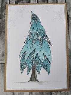 a card with a blue christmas tree on it