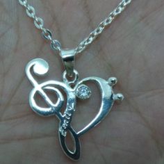 "Discover Music Note Necklace. Base Material: Sterling Silver Size: 23mm (W) X 26 mm (H) (App Plus Hoop) Stone: Cz (Selectable) Chain Length: 16'' - 24'' Inches If you need the item urgently, please contact us for Express Mail. There is an extra cost for Express service. You'll receive Order Shipped Email from us when your item is completed and shipped. SPECIAL ANNOUNCEMENT 1. Please visit https://www.etsy.com/shop/yhtanaff for more designs. 2. Subscribe our newsletter to receive a Coupon Code f Silver Heart-shaped Music-themed Jewelry, Music-themed Silver Heart Jewelry, Treble Clef Necklace, Necklace Music, Music Note Necklace, Music Heart, Bass Clef, Discover Music, Treble Clef