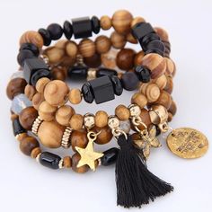 Gorgeous Bracelet Features Wood Beads, Lava Stone, Gold Charms, Coins And Tassels. New Tags: Stars Bangles Tassle Fringe Brown Black Wood Bamboo Butterfly Beaded Star Bangle, Butterfly Charm Bracelet, Wood Bead Bracelet, Bracelets Design, Diy Bracelet Designs, Tassel Bracelet, Bohemian Bracelets, Bead Charm Bracelet, Butterfly Charm