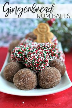 gingerbread rum balls on a plate with sprinkles and christmas tree in the background