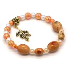 Amber Tones Oval Beads. White & Orange Pearls. Antiqued Gold Leaf Charm. Custom Made. One Size Fits All. One Of A Kind. Classical Styling. Cottage Core Jewelry, Bracelet Pearls, Fork Bracelet, Horn Bracelet, Best Friend Bracelets, Swarovski Crystal Bracelet, Vintage Bangles, Friend Bracelets, Oval Beads