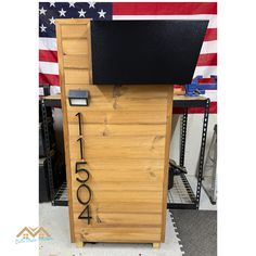 a wooden cabinet with the number one on it and an american flag in the background