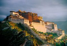 the potala palace is perched on top of a mountain