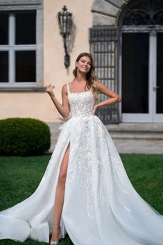 a woman in a white wedding dress posing for the camera with her legs spread out