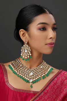 22K Gold plated collar style necklace with kundan embellished motifs, pearl and emerald bead drops. Paired with a pair of kundan earrings.
Components: 1 Necklace, Pair of Earrings
Type: Kundan
Composition: Mixed metal alloy
Color: Gold
Pearl drops
Kundan studded
Closure: Adjustable string - Aza Fashions Kundan Necklace Set, Kundan Necklace, Emerald Bead, Kundan Earrings, Kundan Necklaces, Mens Accessories Jewelry, Jewellery Set, Buy Gold, Indian Jewellery