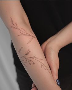 a woman's arm with a flower tattoo on the left side of her arm