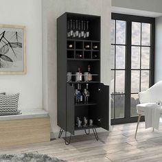 a black cabinet with wine glasses on it in front of a white chair and window