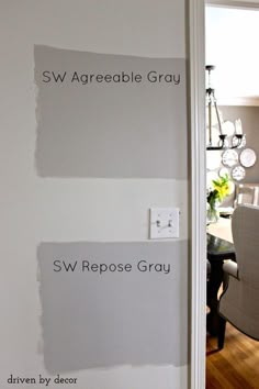 the walls in this dining room are painted white and have different shades of gray on them