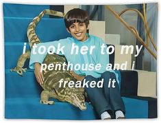 a young boy sitting on top of a blue couch next to a large lizard and the caption reads, i took her to my penhouse and i freaked it