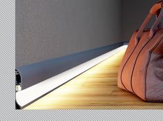 a brown bag sitting on top of a hard wood floor next to a gray wall