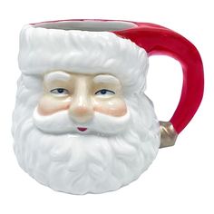 a ceramic santa claus mug with a red handle