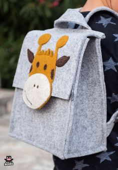 a child's backpack with a giraffe on it