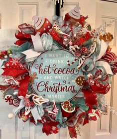 a christmas wreath on the front door with words written in red, white and blue