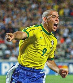 a soccer player with his mouth wide open in front of an audience at a game