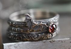 I made this set of 3 intricately patterned  solid sterling silver patterned rings with a sweet little vampire bat, also sterling.  I added a beautiful little genuine 4mm garnet, encased in a serrated sterling bezel.  Widths of bands vary from 2mm-3.5mm. SIZING HINT:  I'd advise ordering 1/2 size up for this wider ring stack if you want to wear them all together, it's much more comfortable to wear. The sterling silver has been darkened/antiqued then polished to bring out the patterns.  Any size. Vampire Ring, Little Vampire, Vampire Wedding, Bat Ring, Gothic Ring, Couples Ring Set, Vampire Bat, Witchy Jewelry, Gothic Rings