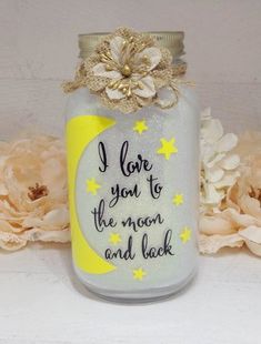 a mason jar with a flower on the top that says i love you to the moon and back