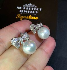 We are presenting you A PAIR OF matching SOUTH SEA PEARLS with LUSTROUS WHITE color. SET IN HANDCRAFTED, 18K SOLID GOLD DROP EARRINGS. ACCENTED WITH 64 E/VS, SPARKLING ROUND BRILLIANT DIAMONDS! IN CASE OF RETURN FOR US BUYERS. BUYERS MAY SEND THE ITEMS BACK TO OUR US-BASED OFFICE IN SALT LAKE CITY, UTAH ONLY ONE ITEM AVAILABLE!! NO DUPLICATES!! WHAT YOU SEE IN THE PICTURES IS WHAT YOU WILL GET SOLIDLY HANDCRAFTED EARRINGS! SUGGESTED RETAIL VALUE: $9,880 PEARLS: Size: 12 mm Shape: Oval/Round Colo Luxury Pearl Earrings With Diamond Accents For Wedding, Luxury Wedding Pearl Earrings With Diamond Accents, White Diamond Pearl Earrings For Formal Occasions, Formal White Brilliant Cut Earrings, Luxury Pearl Earrings With Diamond Accents For Anniversary, White Pearl Earrings With Diamond Accents For Anniversary, White Round Pearl Earrings With Diamond Accents, White Pearl Earrings With Diamond Accents For Wedding, Luxury Diamond Pearl Earrings For Wedding