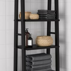 a bathroom shelf with towels and soaps on it