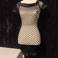 a mannequin is dressed in fishnet clothing