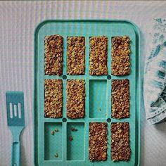 an ice tray filled with granola bars next to a spatula