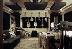 a living room with guitars hanging from the ceiling