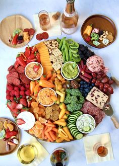 a platter filled with lots of different types of food on top of a table