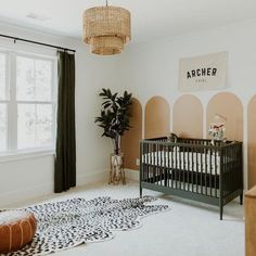 a baby's room with an animal print rug, crib and large window