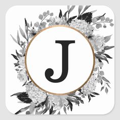 the letter j is surrounded by white flowers and greenery on a square sticker