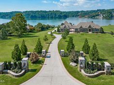 this is an aerial view of a large home in the middle of a beautiful lake