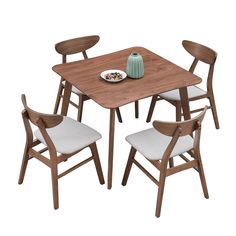 a wooden table with four chairs and a bowl of food on the plate next to it