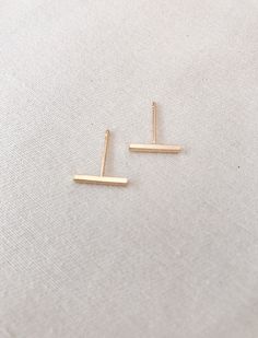 Add a minimalist vibe to your jewelry collection with these bar stud earrings in a silver or gold tone plate. These earrings are elegant for everyday simple glam. Bar Stud Earrings Gold, Bar Top Earring, Bar Top Earring Stud, Couple Accessories, Style Your Outfit, Simple Glam, Line Earrings, Minimalist Vibe, Stamped Earrings