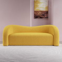 a yellow couch sitting on top of a white floor next to a painting above it