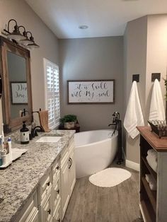 a bathroom with gray walls and white fixtures