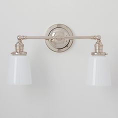 two light bathroom fixture with white glass shades on the side and one light is off