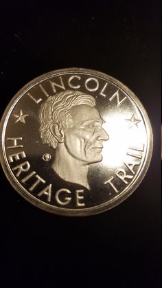 a close up of a coin with the face of a man in profile on it