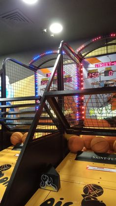 an indoor pinball game is being played at the fairground, with lights on