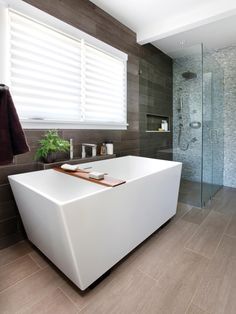 a bath tub sitting next to a walk in shower