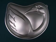 a metal plate with a bird design on it