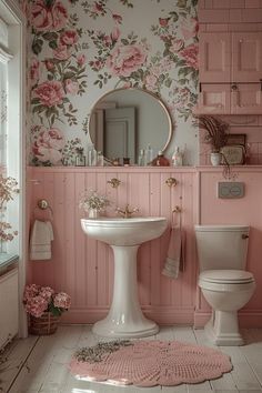 a pink bathroom with floral wallpaper and flooring