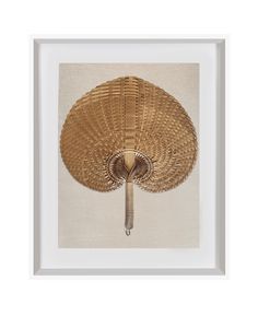 a rattan fan mounted on the wall in a white frame with a beige background