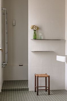 a bathroom with white walls and tiled floors