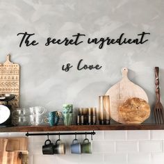 there is a shelf with various kitchen utensils on it and the words, the secret ingredient is love