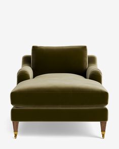 an olive green chair with wooden legs