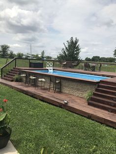 an above ground pool with steps leading up to it and a deck in the foreground