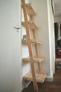 a wooden ladder leaning up against a wall